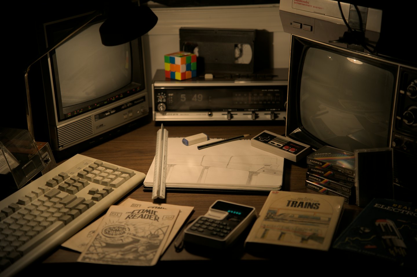 Vintage electronics and hobby supplies arranged on a wooden desk.
